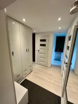 a bathroom with white cabinets and a large mirror at Apartment Kraków-Stare Miasto in Kraków