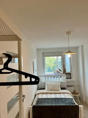 a small bedroom with a bed and a window at Apartment Kraków-Stare Miasto in Kraków