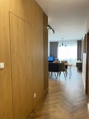a living room with a table and a dining room at Apartament M16 in Limanowa