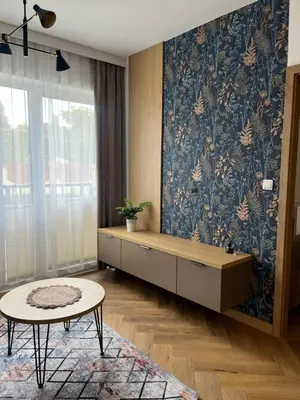 a living room with a bench and a table at Apartament M16 in Limanowa