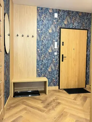 a room with a door and a bench and a wall at Apartament M16 in Limanowa