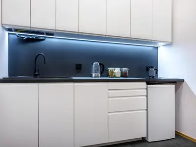 a kitchen with white cabinets and a sink at Golden Market Square Apartments by Tyzenhauz in Kraków