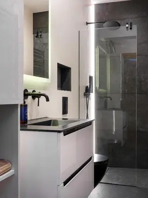 a white bathroom with a sink and a shower at Golden Market Square Apartments by Tyzenhauz in Kraków