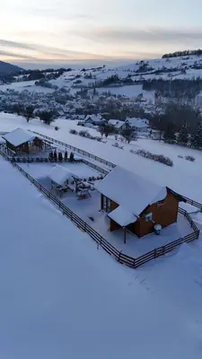 a group of buildings in the snow at Domek całoroczny w Porębie wielkiej z widokiem na góry in Poręba Wielka