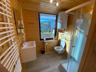 a bathroom with a toilet and a sink and a window at Domek całoroczny w Porębie wielkiej z widokiem na góry in Poręba Wielka