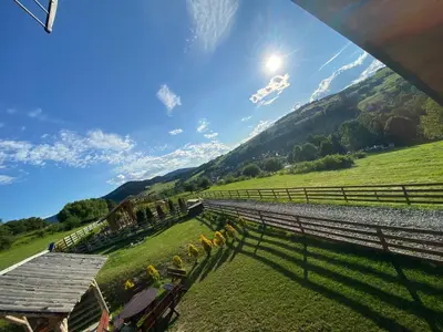 a view of a farm with a fence and a field at Domek całoroczny w Porębie wielkiej z widokiem na góry in Poręba Wielka