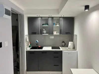 a kitchen with gray cabinets and a sink at Apartament 1 w Kocierzu in Kocierz Rychwałdzki