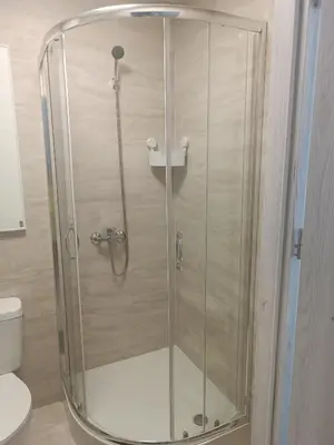 a shower with a glass door in a bathroom at Apartament 1 w Kocierzu in Kocierz Rychwałdzki