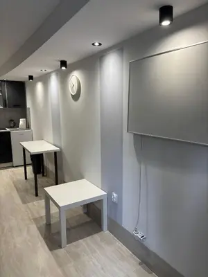 a room with two tables and a projection screen at Apartament 1 w Kocierzu in Kocierz Rychwałdzki