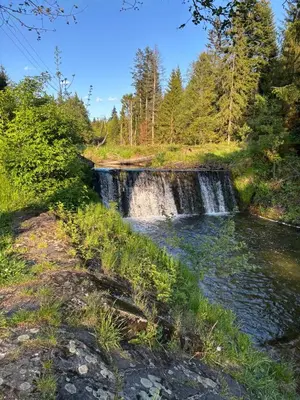 a waterfall in a field next to a river at Apartament 1 w Kocierzu in Kocierz Rychwałdzki