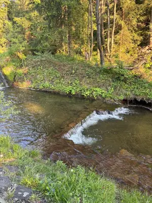 a river with a waterfall in the middle at Apartament 1 w Kocierzu in Kocierz Rychwałdzki