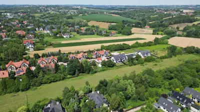 an aerial view of a village with houses and trees at Apartament 294 W Cieniu Drzew by BookingHost in Giebułtów