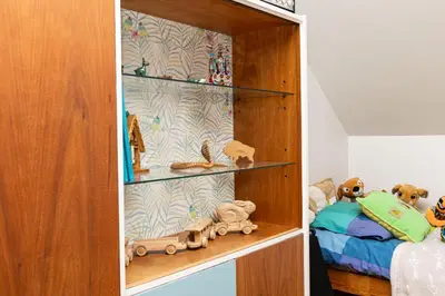 a bedroom with a book shelf and a bed at Apartament 294 W Cieniu Drzew by BookingHost in Giebułtów