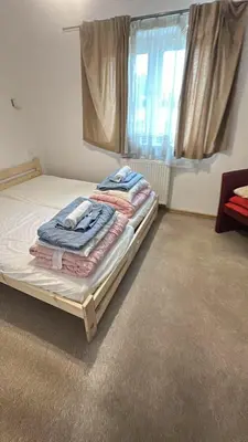 a bed in a room with a window at Dawidapart in Kraków