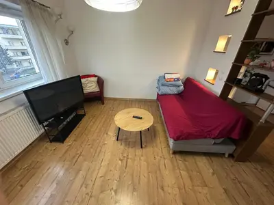 a living room with a couch and a table at Dawidapart in Kraków