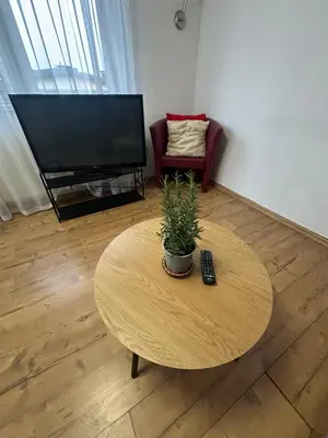 a living room with a coffee table and a television at Dawidapart in Kraków
