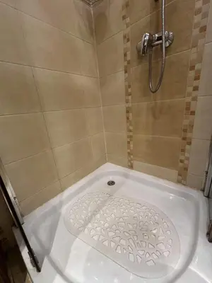 a shower with a white tub in a bathroom at Dawidapart in Kraków