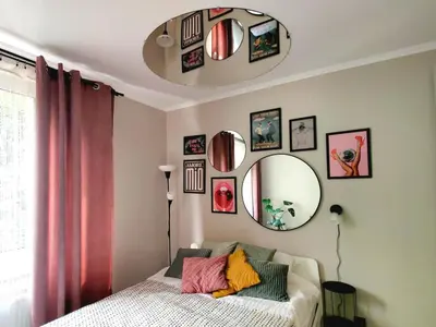a bedroom with a bed and a mirror at Positive Vibes in Kraków