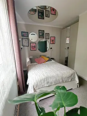 a bedroom with a bed and a plant at Positive Vibes in Kraków