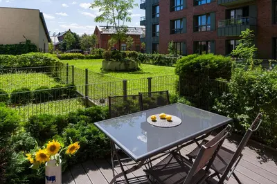a table and chairs with a plate of fruit on it at Chick 1bdr loft in Krakow's city centre in Kraków