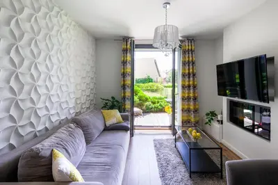 a living room with a couch and a tv at Chick 1bdr loft in Krakow's city centre in Kraków