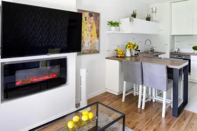 a kitchen with a fireplace and a table in a kitchen at Chick 1bdr loft in Krakow's city centre in Kraków