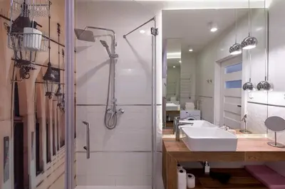 a bathroom with a shower and a sink and a mirror at Chick 1bdr loft in Krakow's city centre in Kraków