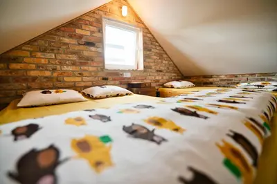 a bedroom with a bed with animals on it at 3 Stodoły - domek 2 in Zator