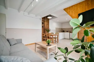 a living room with a couch and a table at 3 Stodoły - domek 2 in Zator