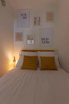 a bedroom with a white bed with two yellow pillows at Apartament HoliStay in Oświęcim