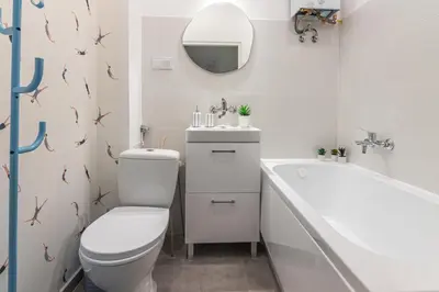 a bathroom with a toilet and a sink and a tub at Apartament HoliStay in Oświęcim