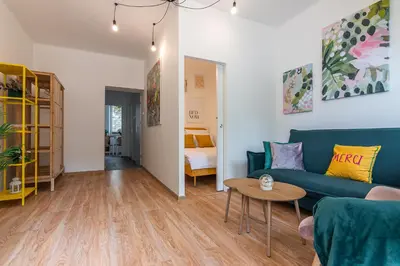 a living room with a blue couch and a table at Apartament HoliStay in Oświęcim
