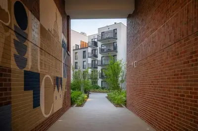 a brick alley way with a building in the background at Apartamenty Lew Invest obok Rynku Głównego, Parking w cenie in Kraków