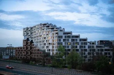 a large white building in front of a highway at Apartamenty Lew Invest obok Rynku Głównego, Parking w cenie in Kraków