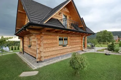 a log cabin with a black roof at Chata Gilowicka - Beskid Żywiecki in Gilowice