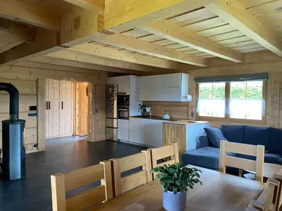 a kitchen and living room with a blue couch and a table at Chata Gilowicka - Beskid Żywiecki in Gilowice