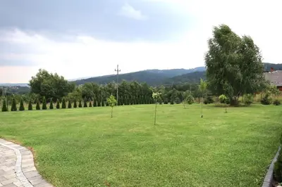 a large green field with trees in it at Chata Gilowicka - Beskid Żywiecki in Gilowice