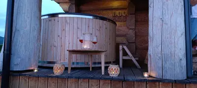 a wooden barrel with a table and candles on a deck at Chata Gilowicka - Beskid Żywiecki in Gilowice