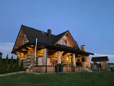 a log home with a black roof at Chata Gilowicka - Beskid Żywiecki in Gilowice