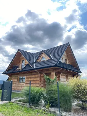 a house with a black roof on top of it at Chata Gilowicka - Beskid Żywiecki in Gilowice