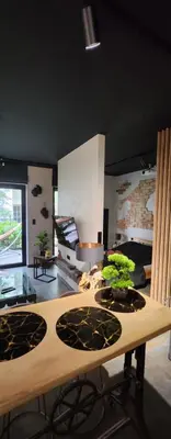 a room with a wooden table with plants on it at Luxury River Side apartament, Free parking in Kraków