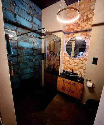 a bathroom with a sink and two mirrors at Luxury River Side apartament, Free parking in Kraków