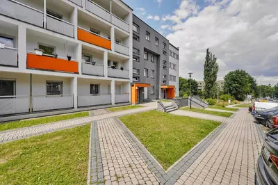 an apartment building with a lawn in front of it at UR4N Apartment - Czarnogórska in Kraków