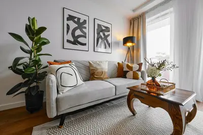 a living room with a couch and a coffee table at UR4N Apartment - Czarnogórska in Kraków
