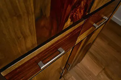 a wooden cabinet with wooden doors on a wooden floor at UR4N Apartment - Czarnogórska in Kraków