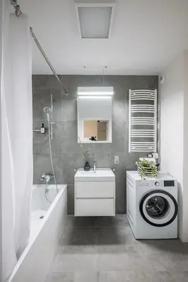 a bathroom with a washing machine and a sink at Apartamenty Lew Invest Wrocławska, Parking w cenie! in Kraków