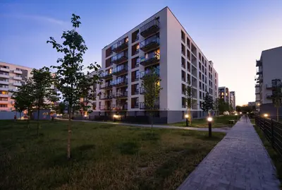 a building in the middle of a city at night at Apartamenty Lew Invest Wrocławska, Parking w cenie! in Kraków