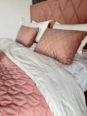 an unmade bed with brown and white sheets and pillows at Chill&Love Apartament