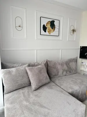 a couch in a living room with a picture on the wall at Chill&Love Apartament