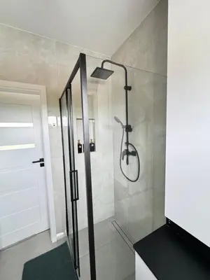 a shower with a glass door in a bathroom at Chill&Love Apartament